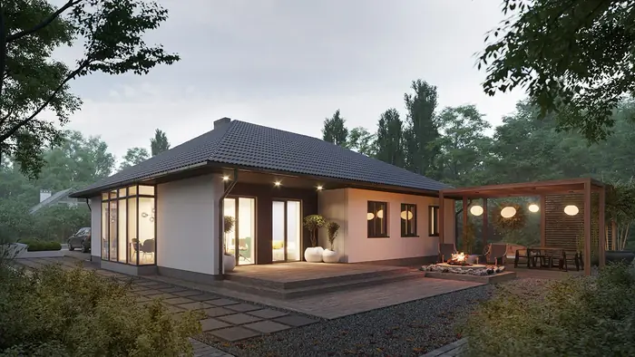 Single-storey house at dusk with a covered terrace, outdoor dining table and hanging lights.